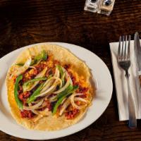 Al Pastor Taco · Marinated pork with pineapple. Over soft corn tortilla topped with cilantro and onions or le...