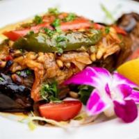 Imam Bayildi · Stuffed eggplant. Whole eggplant served with stuffing prepared from onions, green peppers, t...