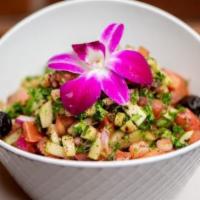 Shepherd Salad · Chopped cucumbers, tomatoes, red onion, and parsley tossed with extra virgin olive oil and v...