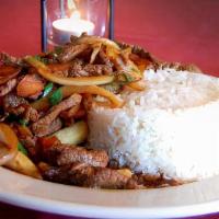 Lomo Saltado · Top sorloin stir Fried with white rice, onions, tomatoes and French fries.