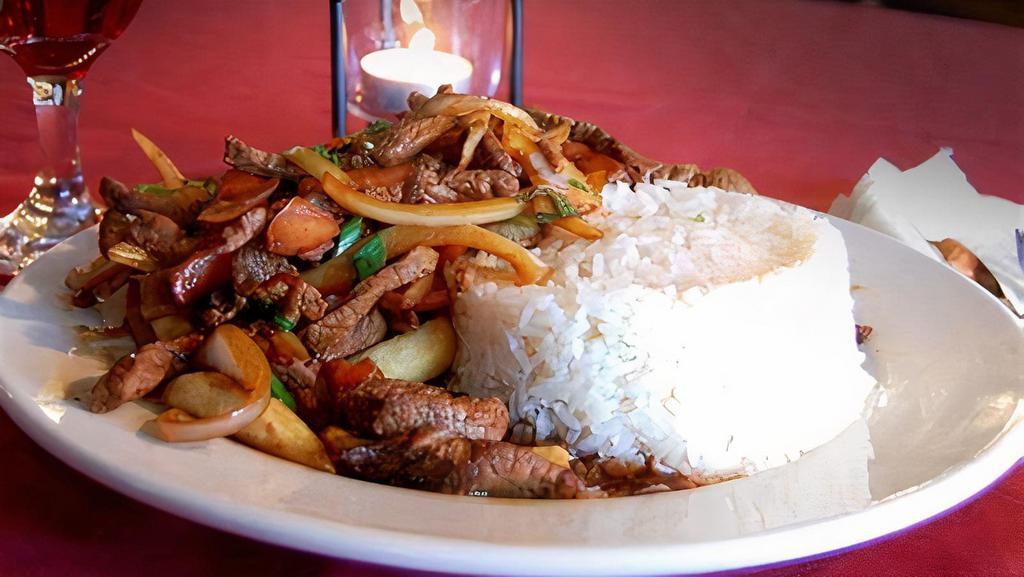 Lomo Saltado · Top sorloin stir Fried with white rice, onions, tomatoes and French fries.
