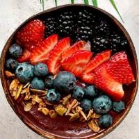 Bom Dia Berry Bowl · Acai bowl topped with blackberries, blueberries, strawberries, and honey.