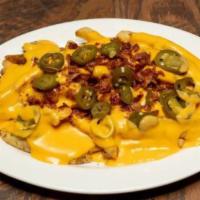 Loaded Fries · Smothered in cheese and topped with crispy bacon and jalapenos.