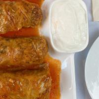 Stuffed Cabbage Rolls · Green cabbage leaves stuffed with rice, ground lamb, herbs and served with garlic yogurt.