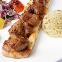 Lamb Shish Kebab · Grilled tender lamb cubes served with rice, cabbage and carrots.