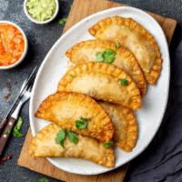 Empanadas · A pastry bread stuffed with your choice of chicken or beef.