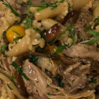Duck Campanelle · Shredded roasted duck, porcini mushrooms, caramelized onions & blistered heirloom tomatoes.