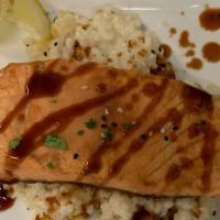 Salmone Toscano · Salmon grilled served over cannellini beans, tomatoes, mushrooms served over spinach in a wh...