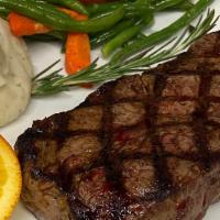 New York Sirloin · 12 oz New York Sirloin Steak served with vegetables and potatoes