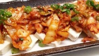 Tofu Kimchi · Spicy. Warm tofu served with sautéed kimchi, scallion, and sesame seeds.