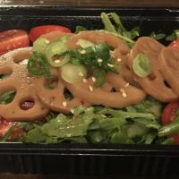 Pickled Lotus Root Salad · Soy based pickled lotus root over arugula, tomato and cucumbers with soy ginger dressing.