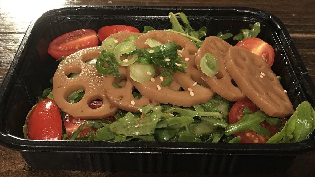 Pickled Lotus Root Salad · Soy based pickled lotus root over arugula, tomato and cucumbers with soy ginger dressing.