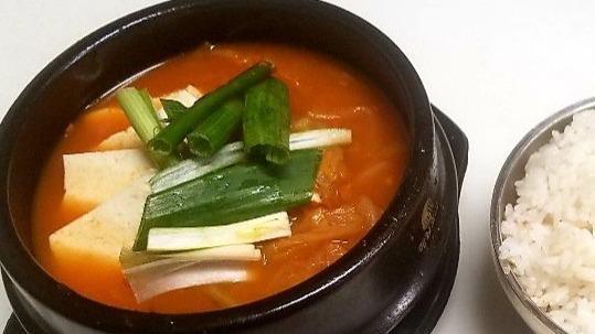 Kimchi Chigae · Spicy. Korean style kimchi stew with pork and tofu served with rice.