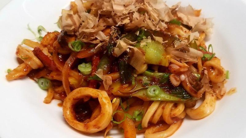 Calamari Bokum · Spicy. Spicy calamari with onion, peppers, mushroom, bonito flakes (dried fish) with udon noodles.