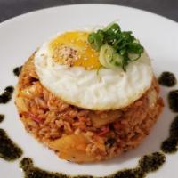 Kimchi Fried Rice · Spicy. Pork or veggie. Rice, onion, scallion, peppers, kimchi, sunny side egg, and sesame se...