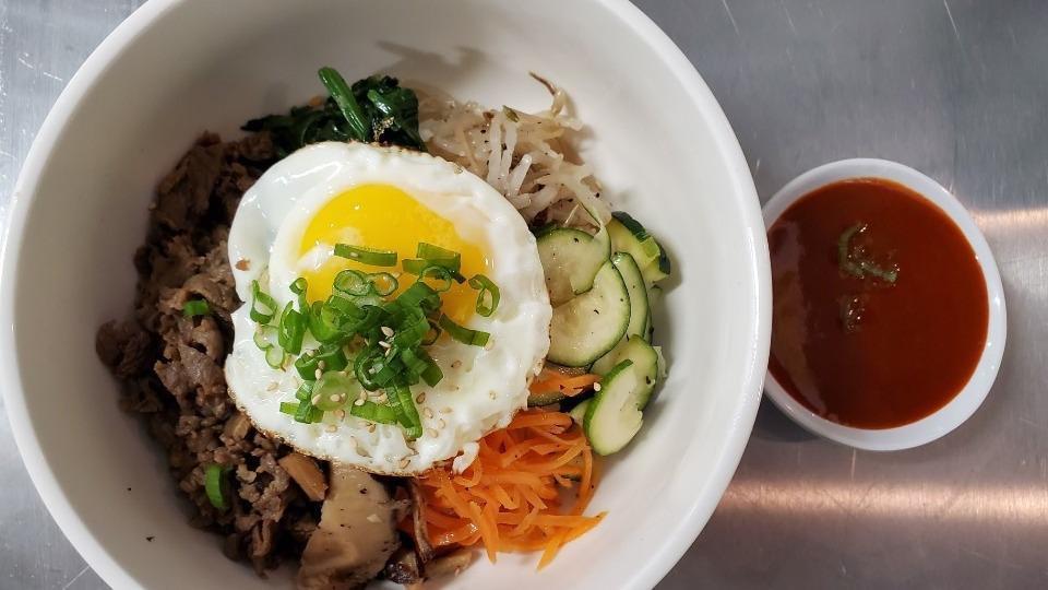 Bibim Bap Lunch Special · Bulgogi, spicy pork, chicken or tofu. Spinach, carrot, shiitake mushroom, green squash, bean sprout, scallion, sesame seeds and oil, sunny side egg.