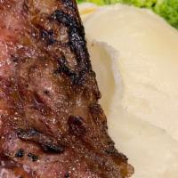 Dry Aged Ny Strip · Herb-rubbed, served with mashed potatoes and a side of your choosing.