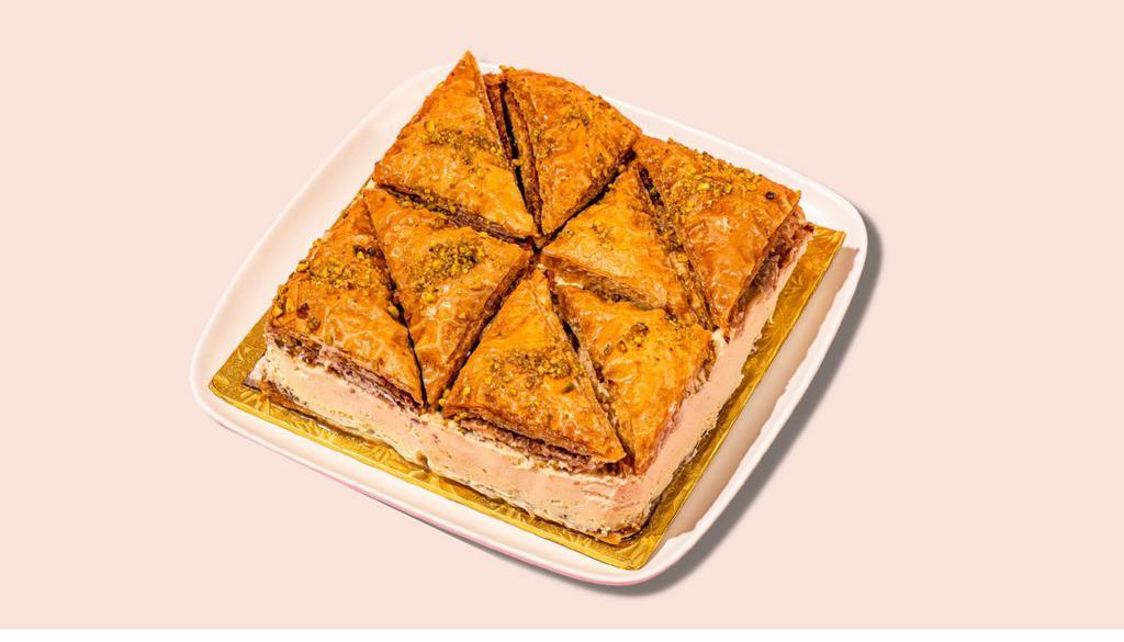 Signature Baklava Cheesecake Whole Cake · TWO AMAZING DESSERTS TOGETHER AS ONE. 
Our signature greek made baklava mixed with original creamy cheesecake.
This Baklava Cheesecake is a luscious twist on the traditional Greek dessert. With all the flavors of cinnamon, honey and walnuts, it’s a delicious way to mix together two delicious desserts into one!
 Delivers Frozen for maximum freshness. Thaws in one hour and is ready to eat.
(Serves 12- 14 People)