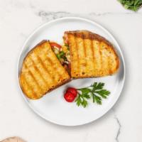 Cluckin' Parm Panini · Breaded chicken, mozzarella cheese, tomato sauce, fresh basil, parmigiana cheese on panini b...