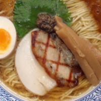 New Tokyo Style Shoyu Ramen · Dark savory chicken truffle and porcini broth with thin flour noodles and topped with grille...