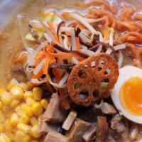 Miso Ramen · Deeply rich mieo and bone deep chicken broth, wavy flour noodles, topped with sweet corn, bo...
