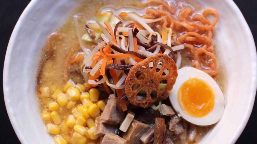 Miso Ramen · Deeply rich mieo and bone deep chicken broth, wavy flour noodles, topped with sweet corn, bok choy, bean sprouts, grilled cheshu pork, sauced soft boiled egg, shredded chili pepper, and pork fat.