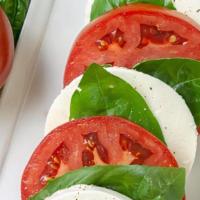 Insalata Caprese · sliced fresh mozzerella, tomatoes, roasted peppers, drizzled with herb infused olive oil