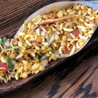 Chowpatty Ki Bhel · Vegan. A classic of the Mumbai street carts- puffed rice mixed with, onions, tomatoes, cilan...