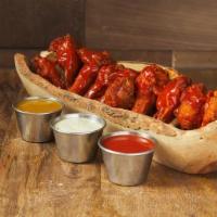 Wings · Dozen meaty bone-in wings, fried, and then tossed in your choice of sauce.