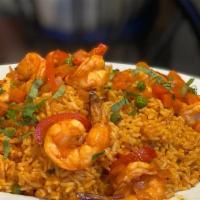 Arroz Con Mariscos · Peruvian style seafood paella made of  rice with seafood and aji amarillo (yellow chili). It...