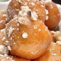 Classic Loukoumades (Honey/Walnuts) V · Baby donuts w/ honey and toasted chopped walnuts