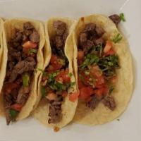 Tacos De Res (4) / Steak Tacos (4) · Taco de bistec con cebolla, cilantro y tomates cortados. / Steak taco with onions, cilantro,...