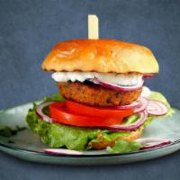 Burger Boom · Mashed chickpeas seasoned with flavor patties browning in skillet and garnish the burger wit...
