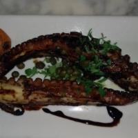 Htapothi Scharas · Classic grilled, marinated octopus with a balsamic reduction sauce, and capers.