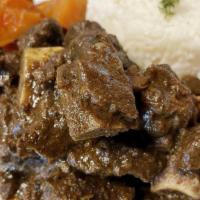 Curried Goat · A caribbean traditional curried goat. This offering is spicy.