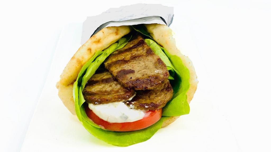 Beef Gyro Pita · Beef gyro served with lettuce, tomato, and tzatziki sauce.