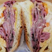 Fat Boy Combination Hero · Hot pastrami, corned beef, american cheese, coleslaw, and russian dressing on a toasted hero.