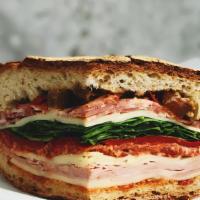 Chicken Club Panini · Grilled chicken, smoked bacon, brie cheese, plum tomatoes, and house dressing on european fl...