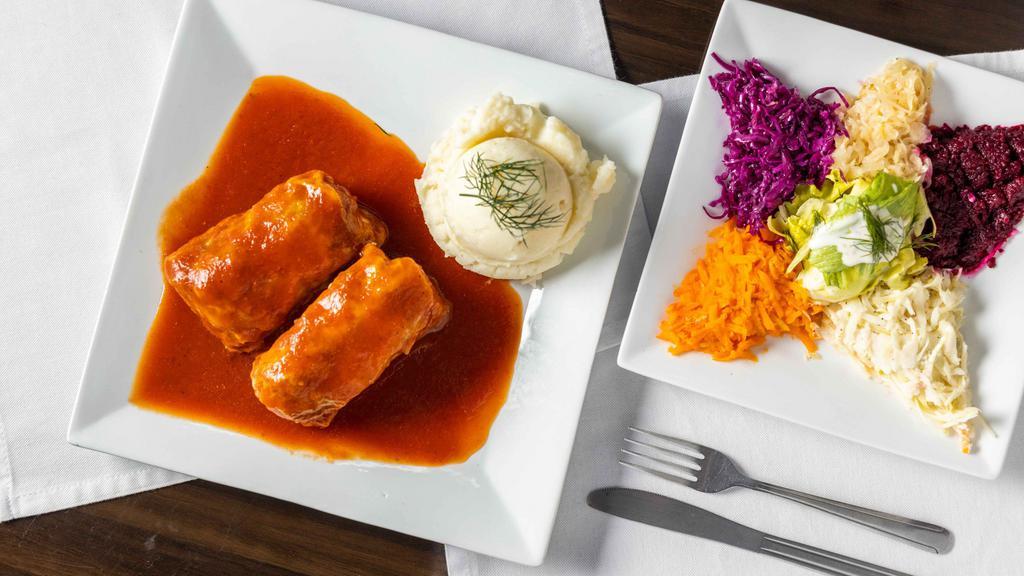 Stuffed Cabbage · Cooked cabbage leaves wrapped around pork meat and rice, cooked delicately to perfection in homemade tomato sauce. Served with house salad.