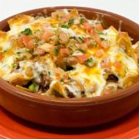 Tex Mex Nachos · House made tortilla chips topped with mixed cheese, seasoned ground beef and pico de gallo