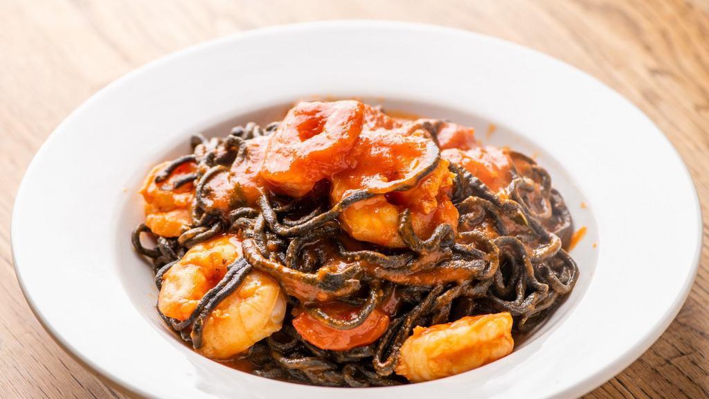 Linguine Nere All'Aragosta · HOMEMADE squid ink linguine with half lobster in tomato sauce.