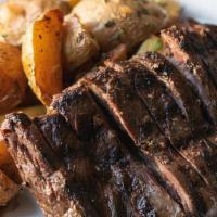 Lombatello · Grilled skirt steak (butcher's steak), thinly sliced and served with roasted potatoes.