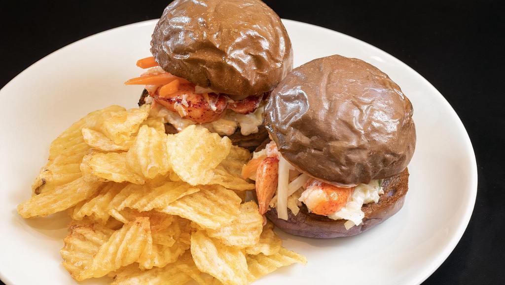 Lobster Sliders · Two lobster sliders on taro buns with coleslaw, pickled daikon, pickled carrots. Served with chips