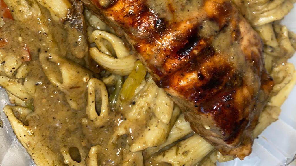 Salmon Dreadlock Pasta · Penne pasta covered with a creamy, spicy Caribbean sauce. Served with jerk bbq salmon.