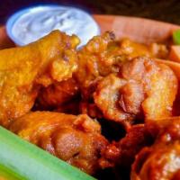 Waylon Wings · Crispy wings, topped with your choice of buffalo or BBQ sauce served with our cotija ranch d...