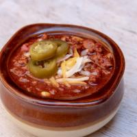 Bowl Of Chili · Housemade chili, topped with shredded queso, sour cream, and pickled jalapenos.