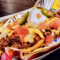 Frito Pie · Fritos served with housemade chili, topped with shredded queso, sour cream, and pickled jala...