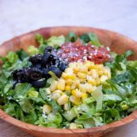 Texas Chopped Salad · Romaine, roasted sweet corn, tomato, and olives, topped with queso fresco, served with citru...