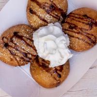 Fried Oreos · Hand-dipped in pancake batter and fried, with chocolate sauce and powdered sugar.