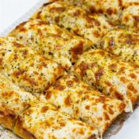 Cheesy Sticks · Ten pieces of freshly baked bread covered with cheese and topped with spices